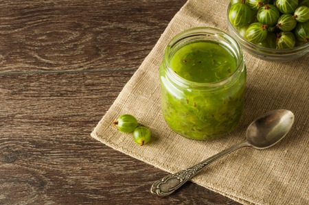 Gooseberry smoothie in a jar on a brown table.の写真素材