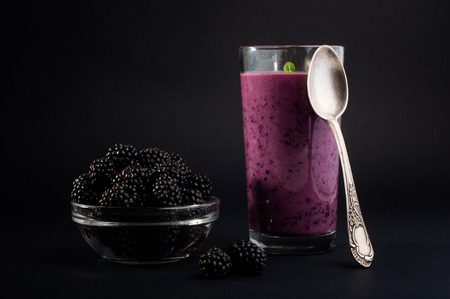Blackberry jogurt smoothie in glass and fresh berries seriesの写真素材