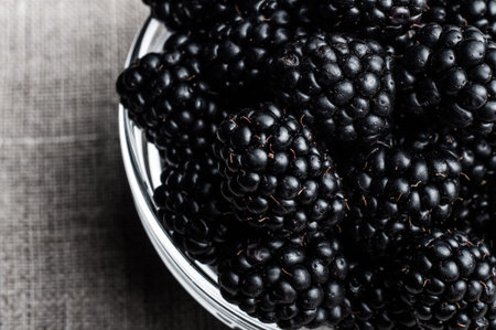 Fresh Ripe Juicy Blackberries in a plate on black background