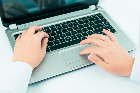 Female hands or woman office worker typing on the keyboardの写真素材