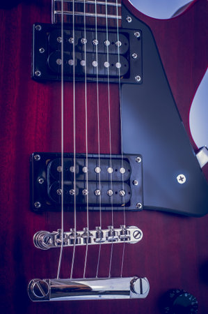 Part electric guitar and classic amplifier on a dark background.