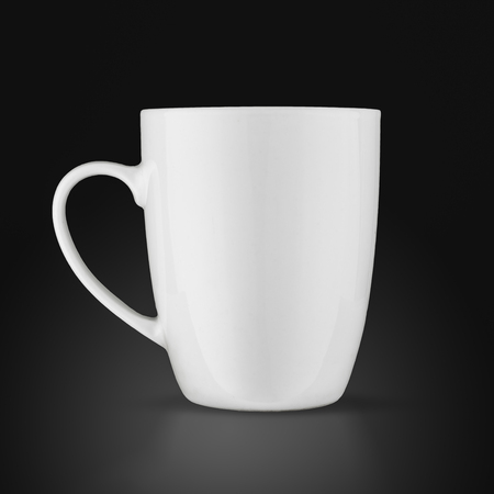 White cup isolated on black background.の写真素材