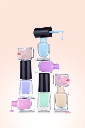 Bottles with spilled nail polish over gradient backgroundの写真素材