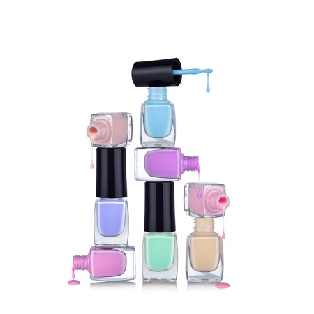 Bottles with spilled nail polish over a white backgroundの写真素材