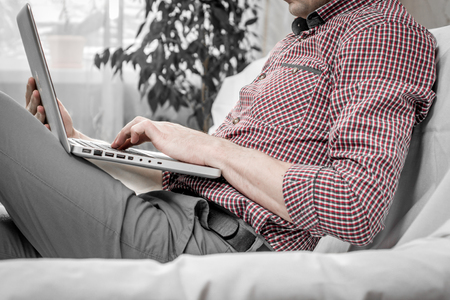 elegant business multitasking multimedia man using devices at homeの写真素材