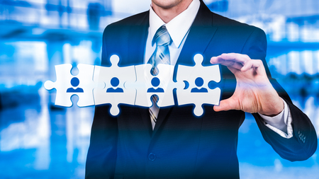 HR - Human Resources - business concept with hand businessman and puzzle.の写真素材