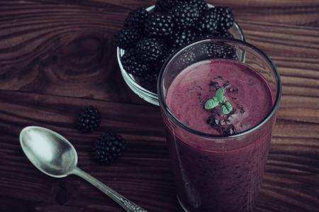 Blackberry jogurt smoothie in glass and fresh berries seriesの写真素材