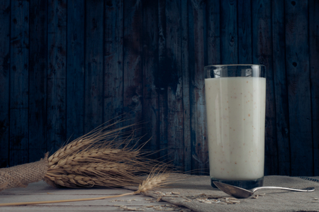 Fresh dairy products and wheat on rustic wooden background.の写真素材