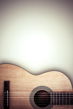Part of an acoustic guitar on a grey backgroundの写真素材