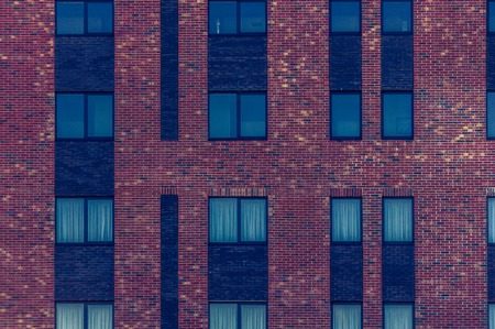 Wall of red brick with windows. Pattern.の写真素材