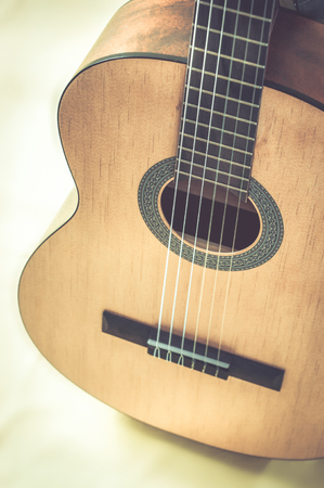 Part of an acoustic guitar on a grey backgroundの写真素材