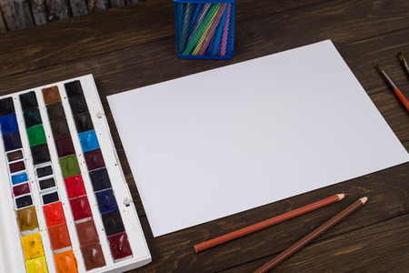Paints, pencils and brushes on wooden to a floor. Image preprocessing.の写真素材