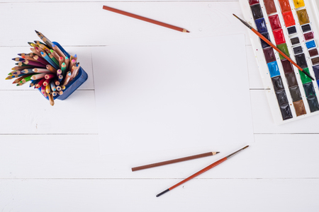 Paints, pencils and brushes on wooden to a floor. Image preprocessing.の写真素材