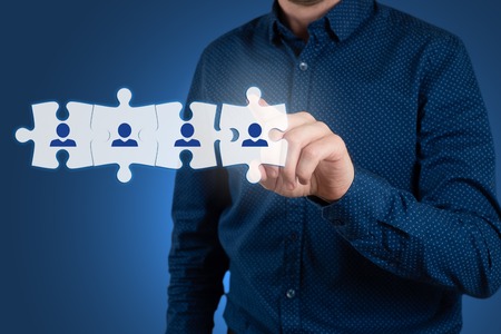 HR - Human Resources - business concept with hand businessman and puzzleの写真素材