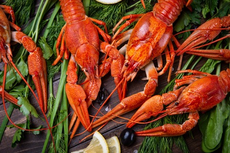 Crayfish. Red boiled crawfishes on table in rustic style, closeup. Lobster closeup.の写真素材