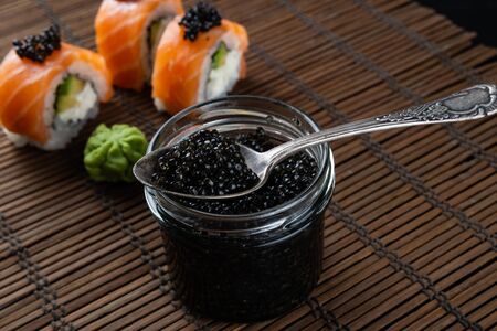 Sushi roll Philadelphia with salmon, smoked eel, avocado, cream cheese on black background. Japanese food.の写真素材