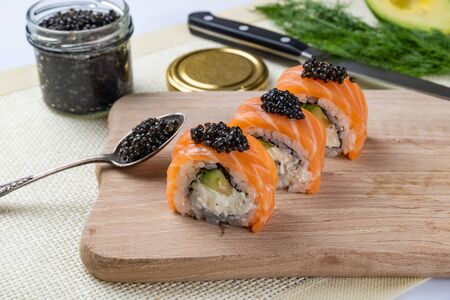 Sushi roll Philadelphia with salmon, smoked eel, avocado, cream cheese on black background. Japanese food.の写真素材