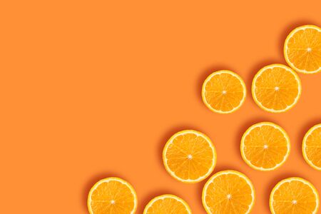 Pieces of orange on an orange backgroundの写真素材