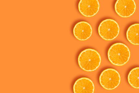 Pieces of orange on an orange backgroundの写真素材
