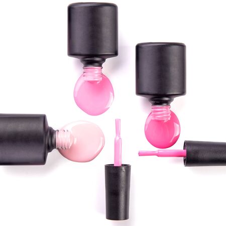 Bottles with spilled nail polish over white backgroundの写真素材