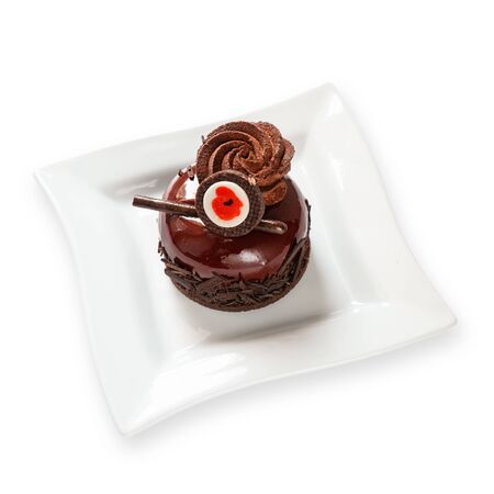 Delicious chocolate cake on plate on light backgroundの写真素材