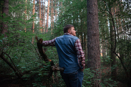 A man walks through the coniferous forest. high quality photoの写真素材