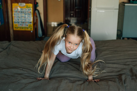 portrait of a smiling child, listening to music in white headphones, dancing, fooling around at...