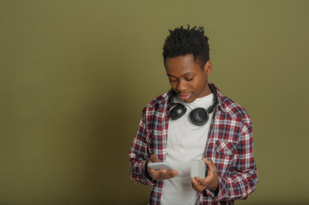 young black guy connects bluetooth speaker to phoneの写真素材