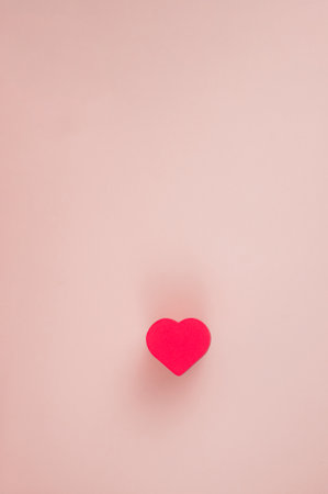 one red hearts on a pink backgroundの写真素材