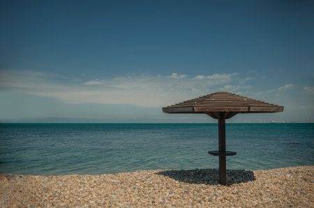 Wooden beach umbrellas by the sea in clear weatherの写真素材