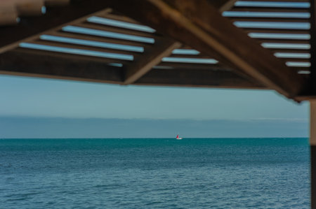Wooden beach umbrellas close up by the sea in clear weatherの写真素材