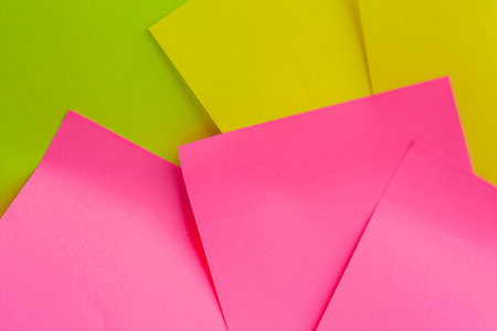 yellow, green, pink sticky note close up on white background. Color paper note. Back to school...