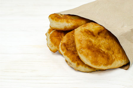 Assortment of pastries in paper ecological bags on a white wooden backgroundの写真素材