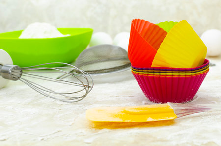 Close-up of cupcake molds on floured table, culinary utensilsの写真素材