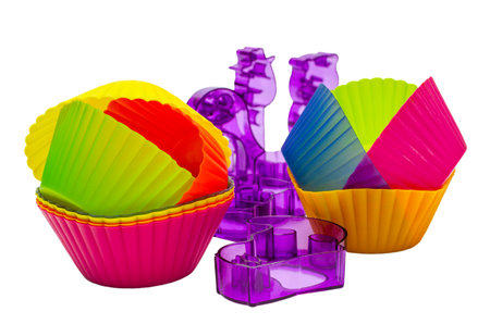 Many different molds for baking on a white background. Culinary accessories of the baker. Small baking cups. It is isolated.の写真素材