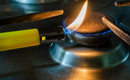 Close-up of Ignited flame on a spark gas igniter . Concept of gas shortage and crisis.