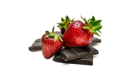 Pieces of chocolate and strawberries on isolated backgroundの写真素材