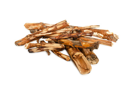 Collection of dry, natural firewood stacked in a pile on a clean white background.の写真素材