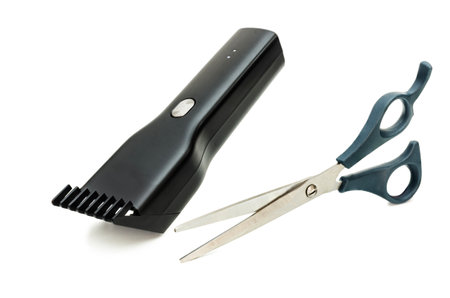 This image showcases a close-up of a sleek black hair trimmer and a pair of silver scissors with ergonomic blue handles, set against a clean white backdrop.の写真素材