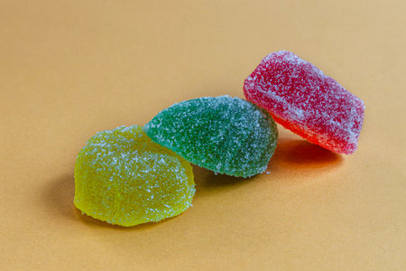 Jelly candies or gummy candies on paper colored backgroundの写真素材