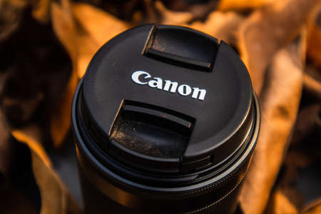 bogor,indonesia - 07 july 2021 : canon lens on a pile of dry leaves with morning lightのeditorial素材