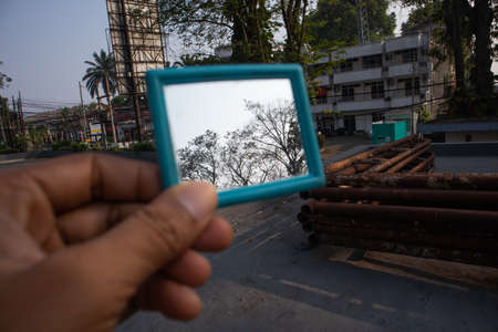 bogor, indonesia - 7 july 2021 : hand holding glass with blur backgroundのeditorial素材