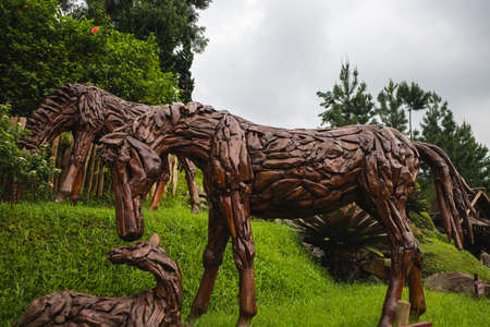 a horse statue made of wood in an open gardenのeditorial素材