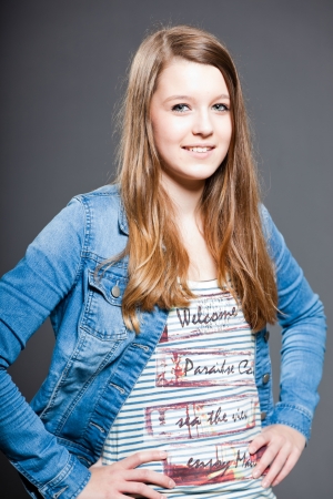 Pretty happy brunette teenage girl. Studio shot.の写真素材