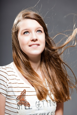 Pretty happy brunette teenage girl. Studio shot.の写真素材
