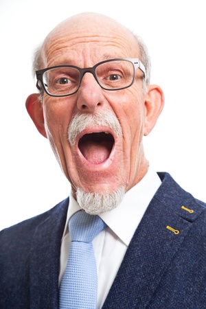 Angry well dressed senior man with glasses. Isolated.の写真素材