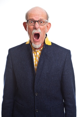 Angry well dressed senior man with glasses. Isolated.の写真素材
