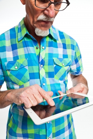 Well dressed senior man with tablet computer. Isolated.の写真素材