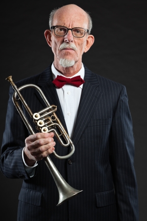 Senior jazz musician. Trumpet player. Studio shot.の写真素材