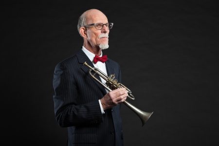 Senior jazz musician. Trumpet player. Studio shot.の写真素材